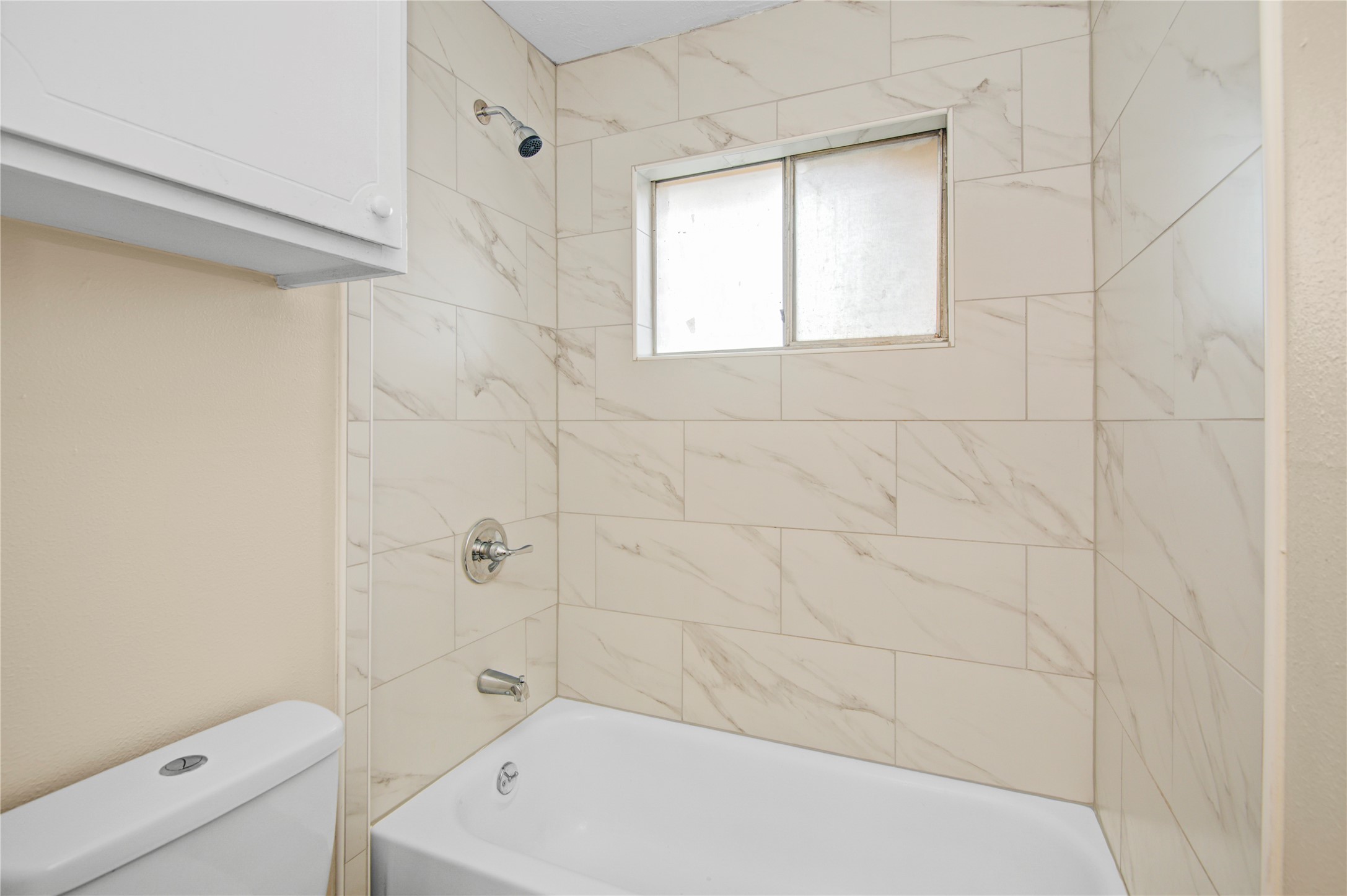 1230 Epsilon Street Pasadena, TX 77504 - Photo 16 of 27 a bathroom with a white bath tub a toilet and a shower