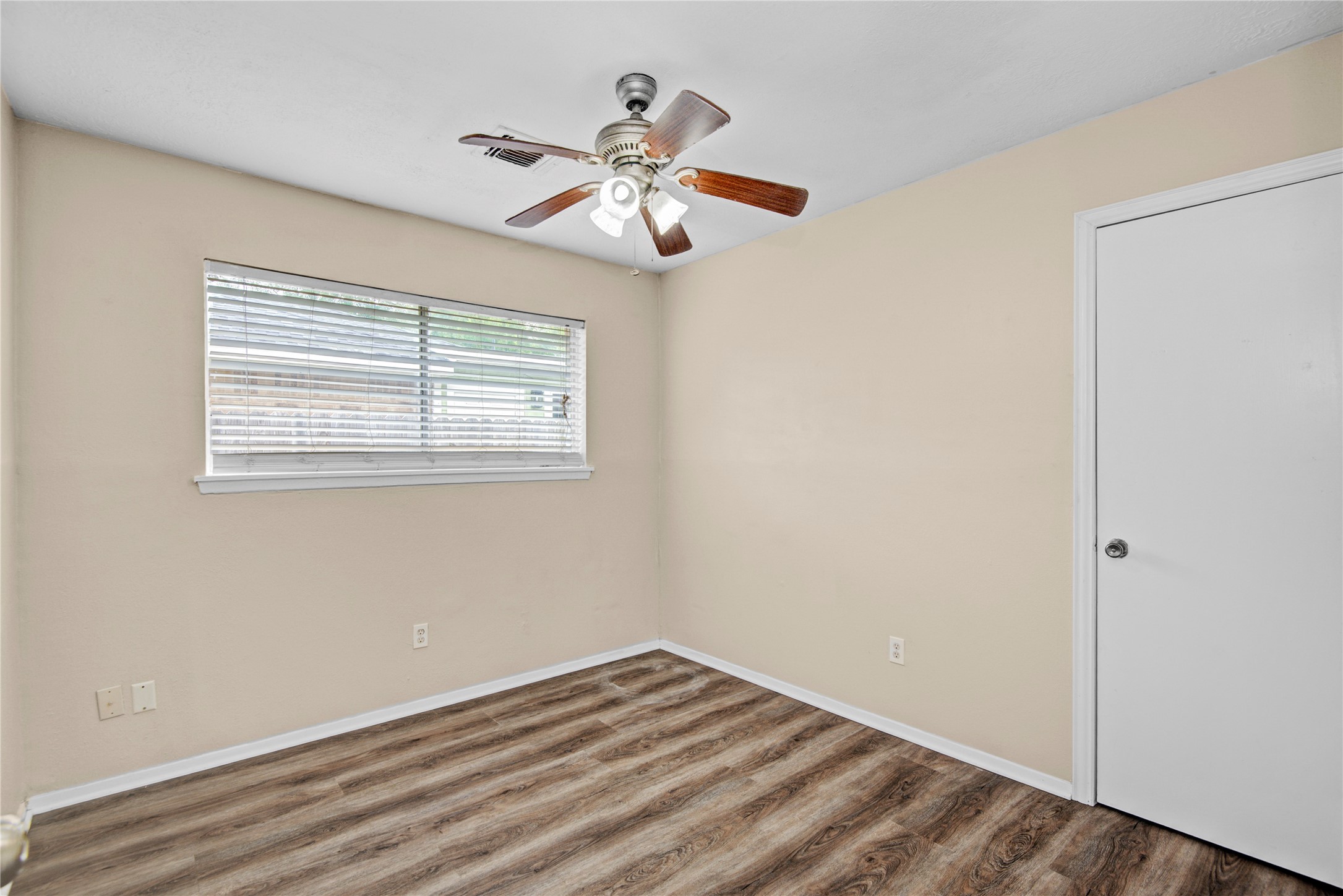 1230 Epsilon Street Pasadena, TX 77504 - Photo 17 of 27 a view of an empty room with wooden floor and a window