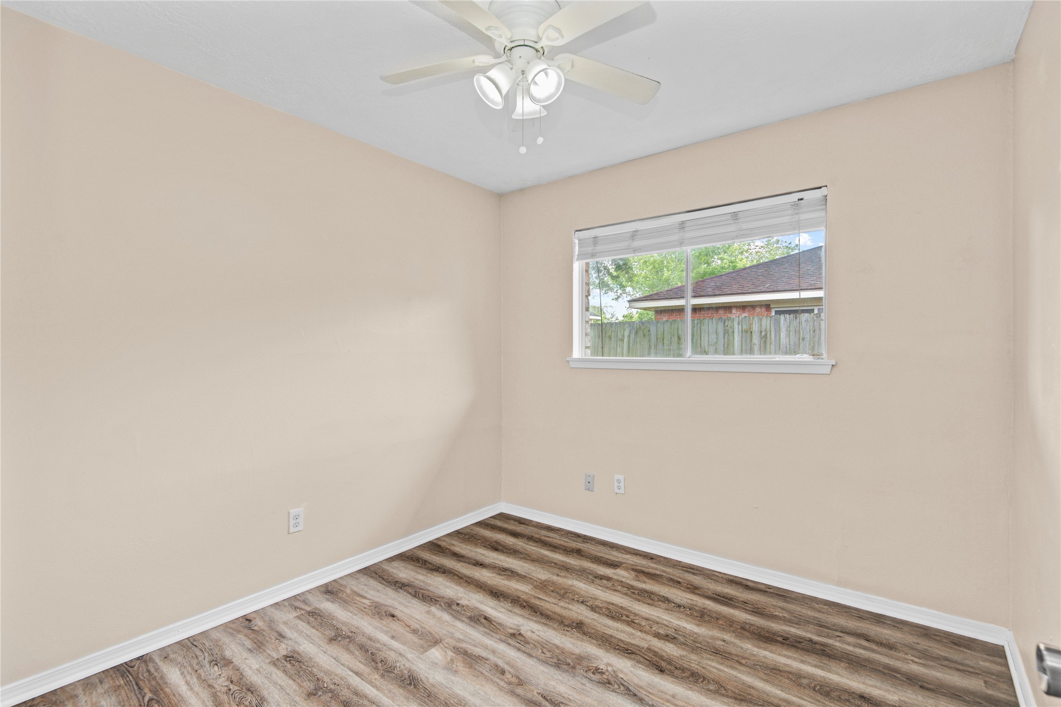 1230 Epsilon Street Pasadena, TX 77504 - Photo 19 of 27 an empty room with a window and a fan