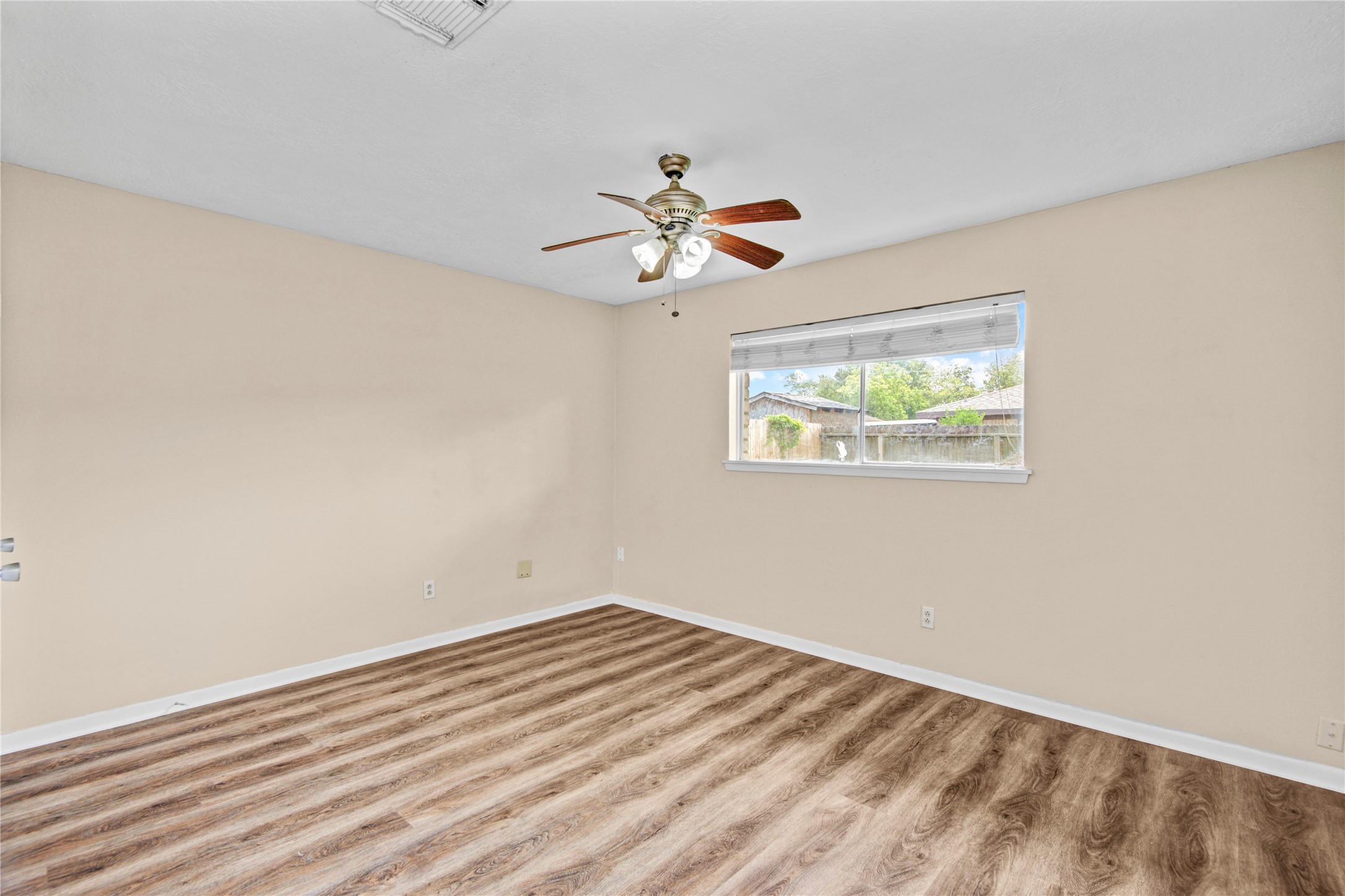 1230 Epsilon Street Pasadena, TX 77504 - Photo 21 of 27 a view of a room with a ceiling fan and a window