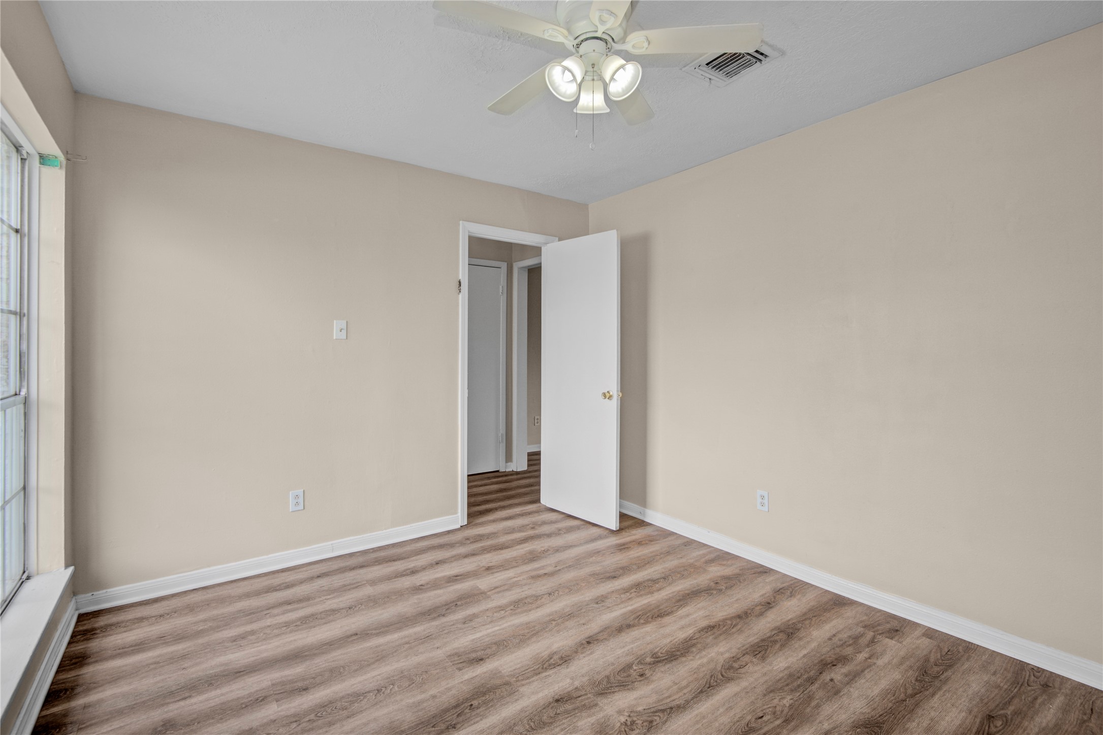 1230 Epsilon Street Pasadena, TX 77504 - Photo 7 of 27 a view of an empty room with wooden floor
