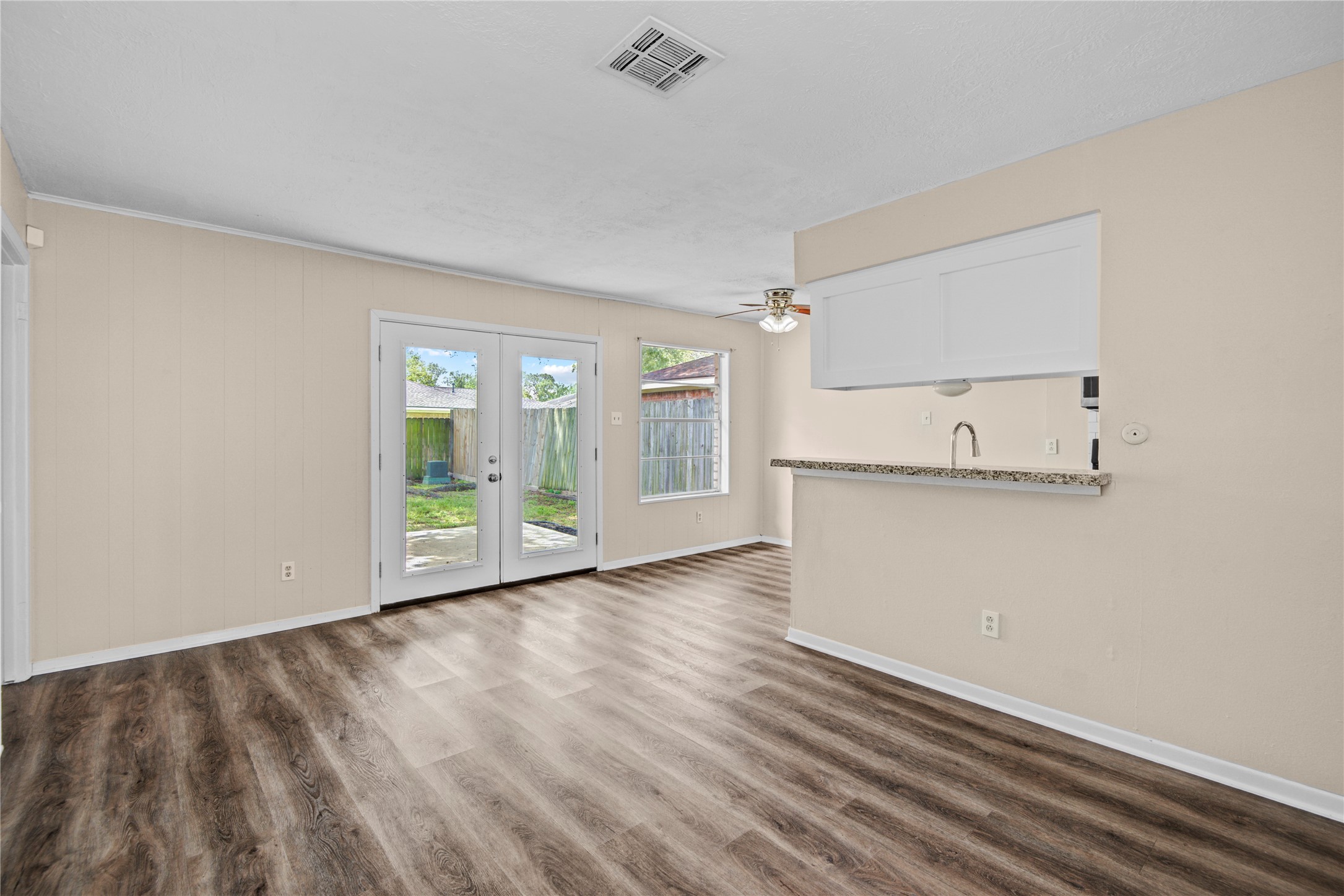 1230 Epsilon Street Pasadena, TX 77504 - Photo 8 of 27 a view of empty room with wooden floor and fan