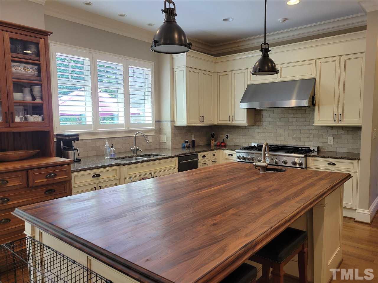 7 Springhouse Place Durham, NC 27705 - Photo 11 of 30 a kitchen with a stove center island and cabinets