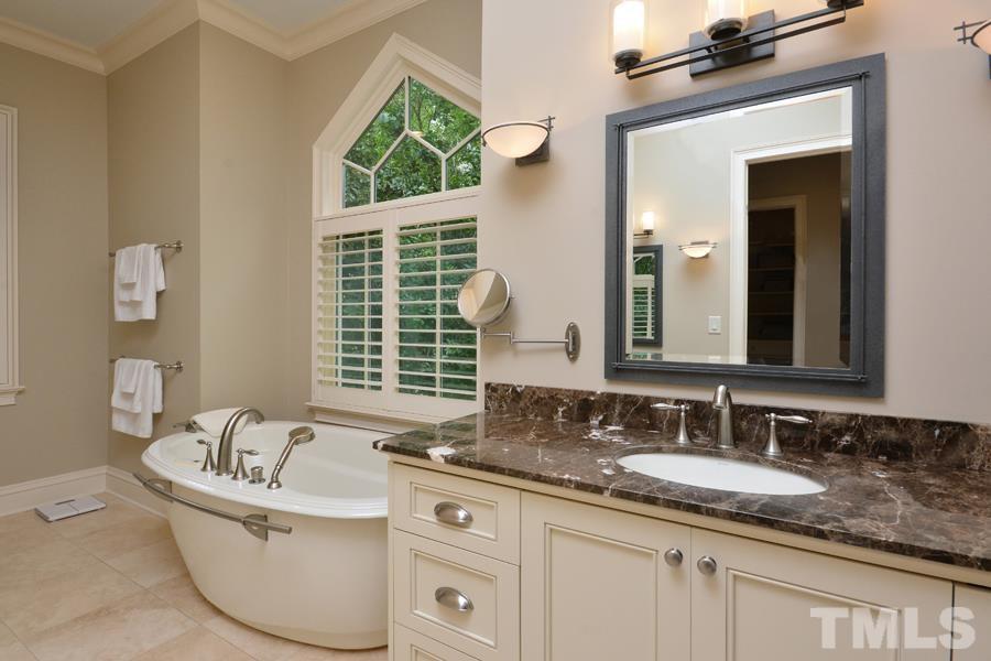 7 Springhouse Place Durham, NC 27705 - Photo 20 of 30 a bathroom with a granite countertop tub sink and mirror