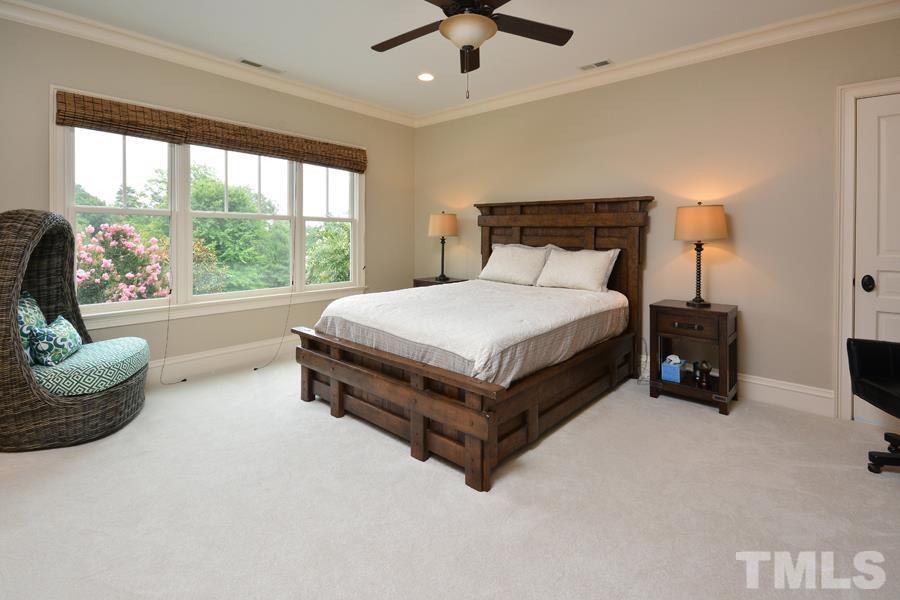 7 Springhouse Place Durham, NC 27705 - Photo 23 of 30 a bed sitting in a spacious bedroom next to a window