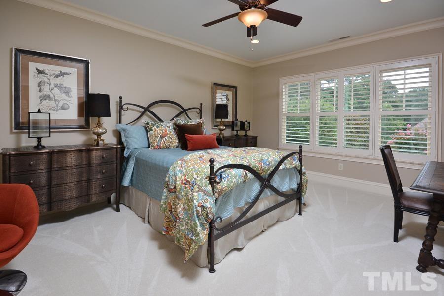 7 Springhouse Place Durham, NC 27705 - Photo 25 of 30 a bed room with a bed and a chandelier
