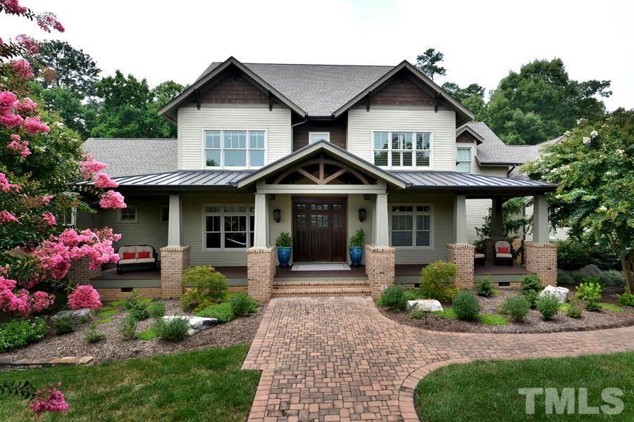 7 Springhouse Place Durham, NC 27705 - Photo 5 of 30 a front view of a house with a yard and garage