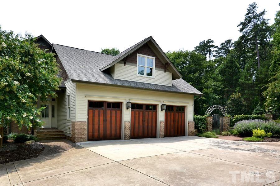 7 Springhouse Place Durham, NC 27705 - Photo 6 of 30 a front view of a house with a yard and garage