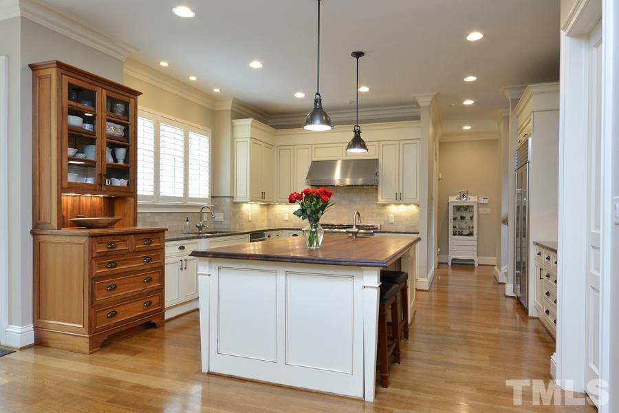 7 Springhouse Place Durham, NC 27705 - Photo 8 of 30 a kitchen with counter top space and living room view