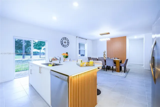 a kitchen with a sink and breakfast area