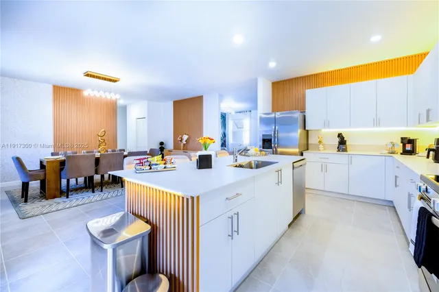 a kitchen with stainless steel appliances kitchen island granite countertop a sink and cabinets