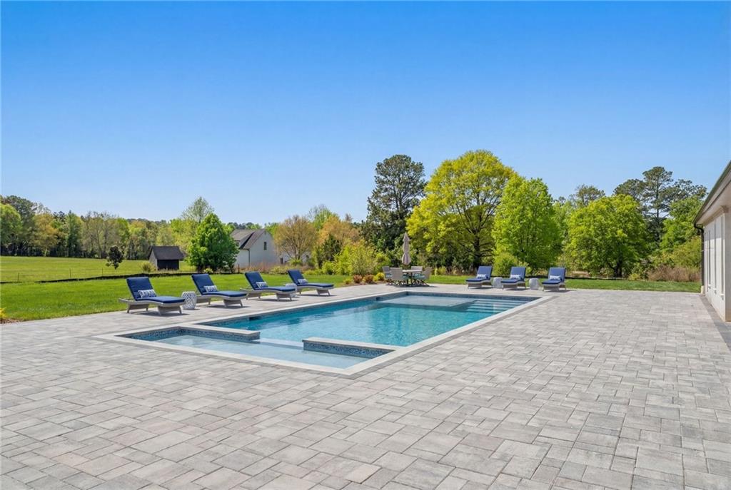 3215 Indian Shoals Road Dacula, GA 30019 - Photo 16 of 18 a view of swimming pool with outdoor seating and yard in the back