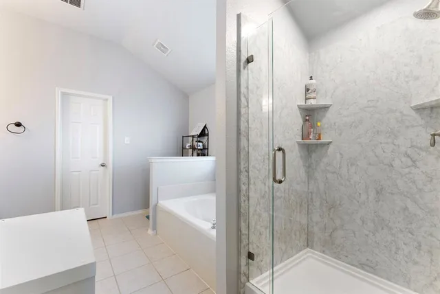 a bathroom with a bathtub and shower