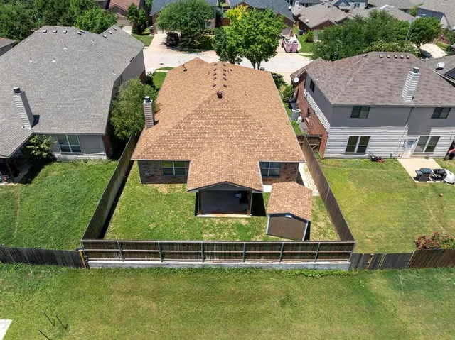 an aerial view of a house with a swimming pool