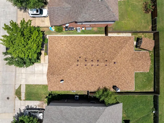 an aerial view of a house with a yard