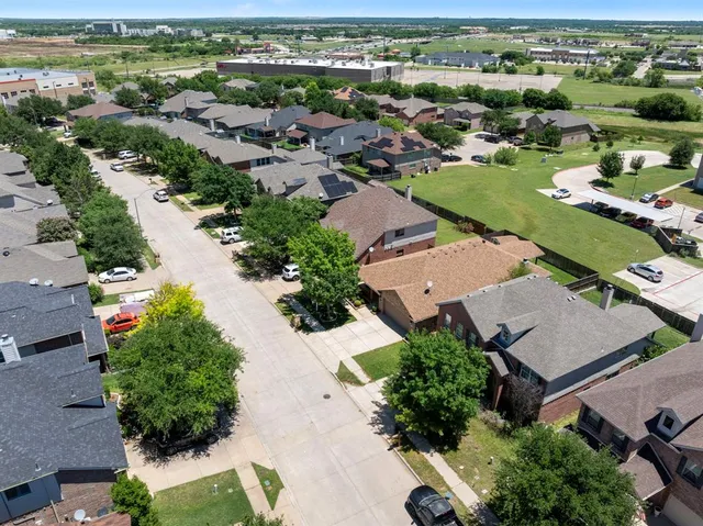 an aerial view of residential houses with outdoor space
