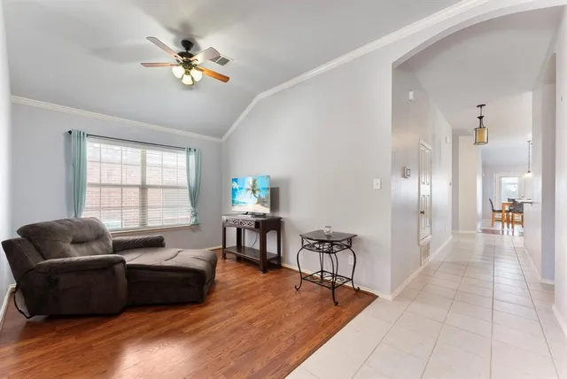 a living room with furniture and wooden floor
