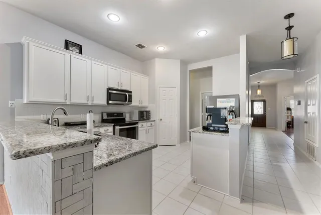 a kitchen with sink cabinets and living room
