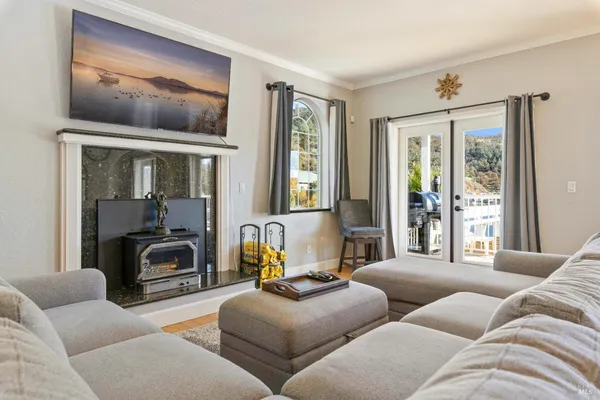 a view of a livingroom with furniture a table and wooden floor