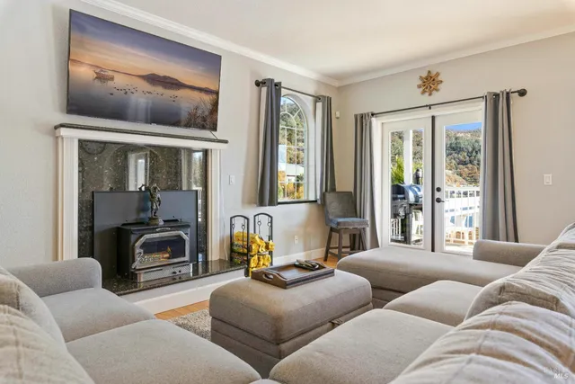 a white toilet sitting next to a wooden cabinet
