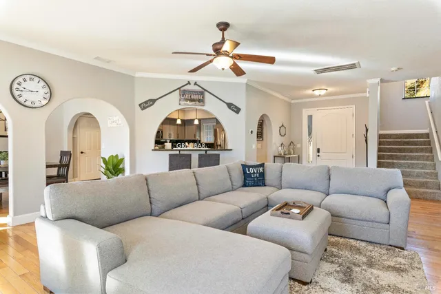 a bedroom with a bed lamp and a large window