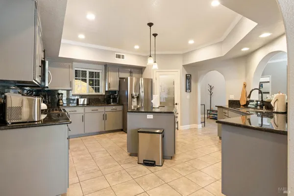 a kitchen with granite countertop a sink and cabinets