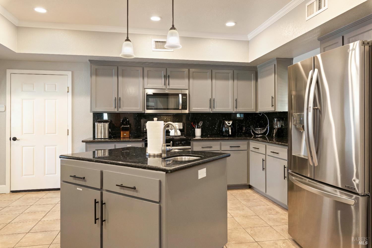 11115 Lakeshore Drive Clearlake, CA 95422 - Photo 20 of 69 a kitchen with kitchen island granite countertop stainless steel appliances cabinets a sink and a counter space