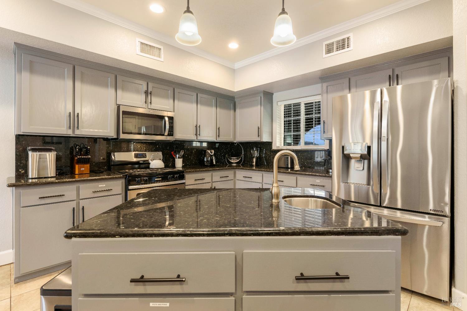 11115 Lakeshore Drive Clearlake, CA 95422 - Photo 21 of 69 a kitchen with stainless steel appliances granite countertop a sink a stove and cabinets