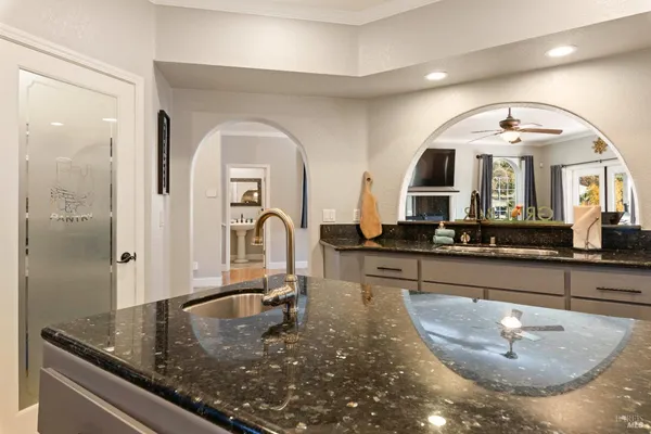 a bathroom with a granite countertop sink and a mirror