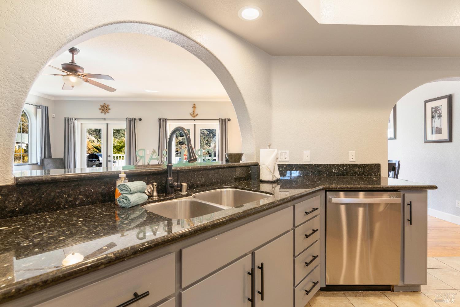 11115 Lakeshore Drive Clearlake, CA 95422 - Photo 25 of 69 a kitchen with granite countertop a sink and cabinets