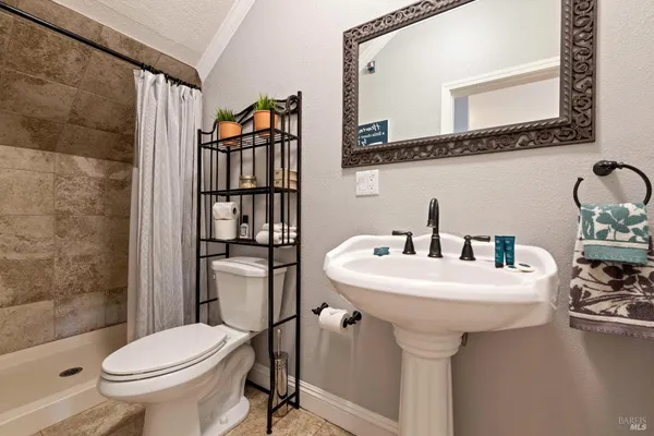 a bedroom with a bed lamp and a large window