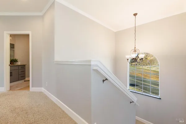 a bedroom with a large bed and a flat tv screen