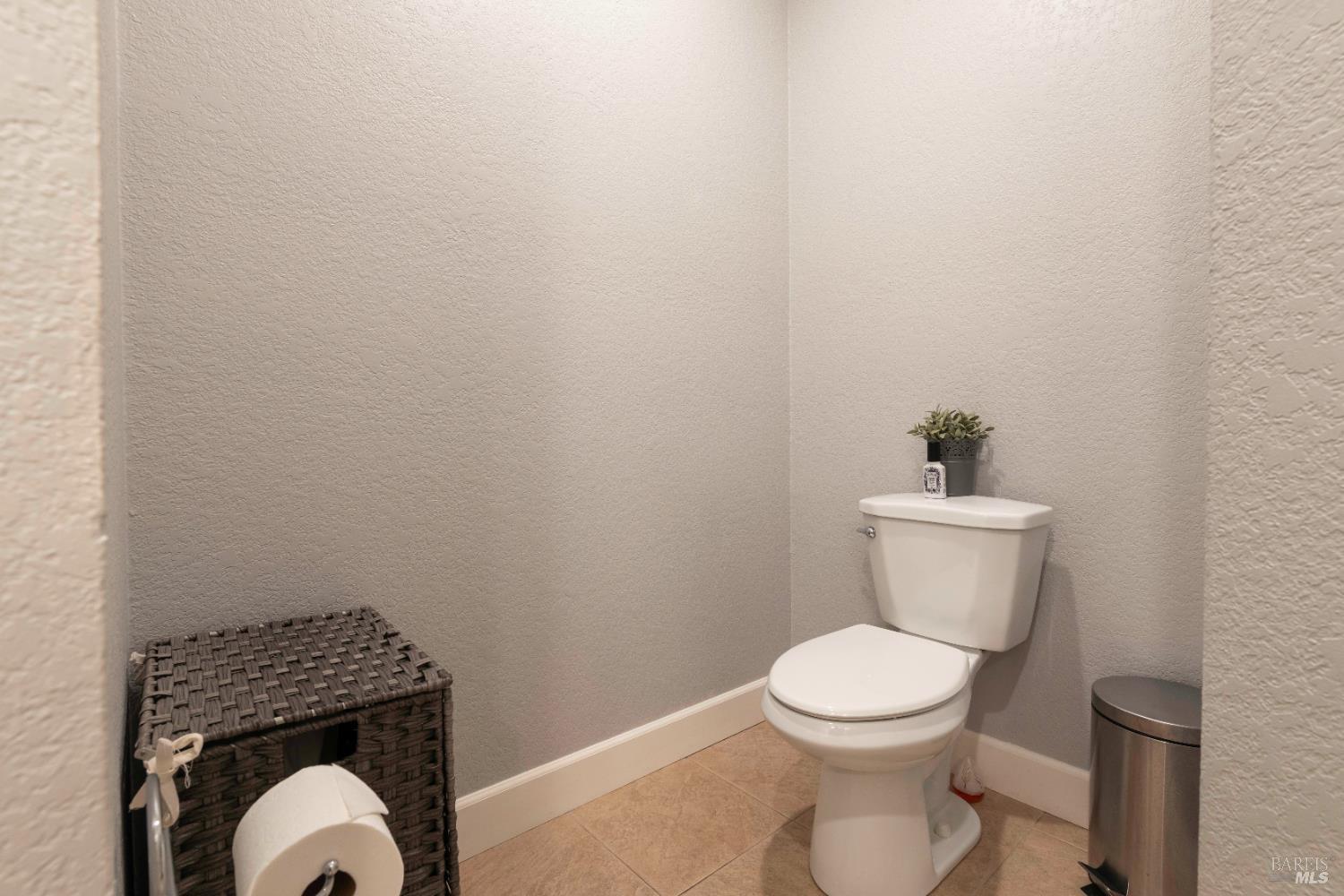 11115 Lakeshore Drive Clearlake, CA 95422 - Photo 31 of 69 a white toilet sitting next to a wooden cabinet