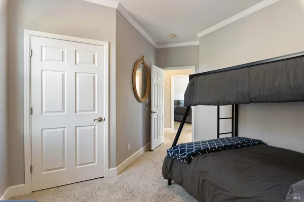a bedroom with a flat screen tv and a bed