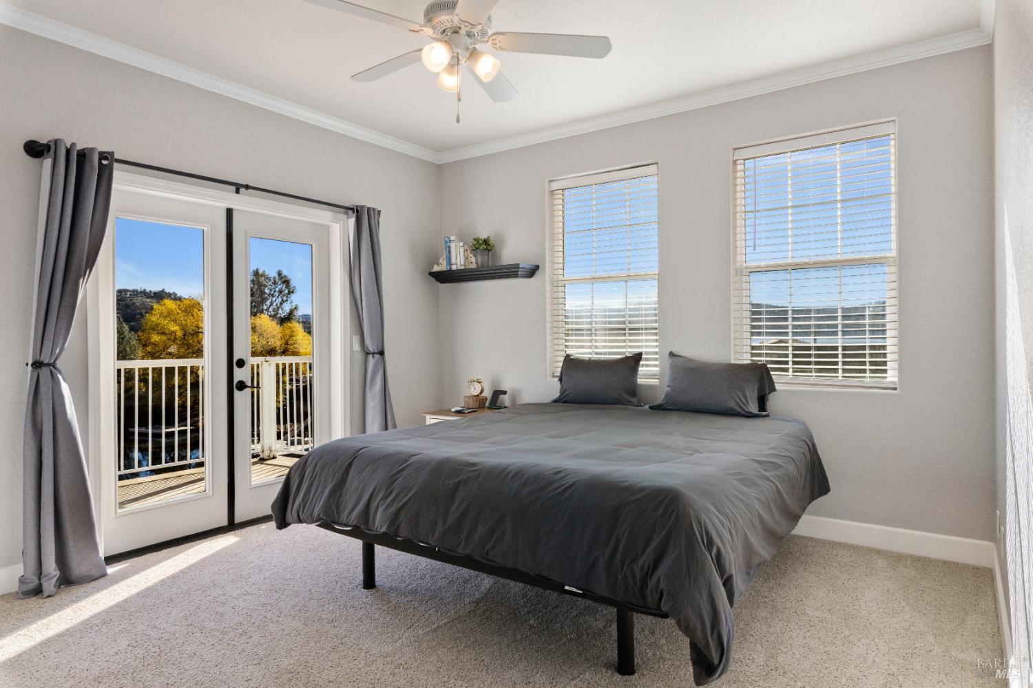 11115 Lakeshore Drive Clearlake, CA 95422 - Photo 34 of 69 a bedroom with a bed lamp and a large window