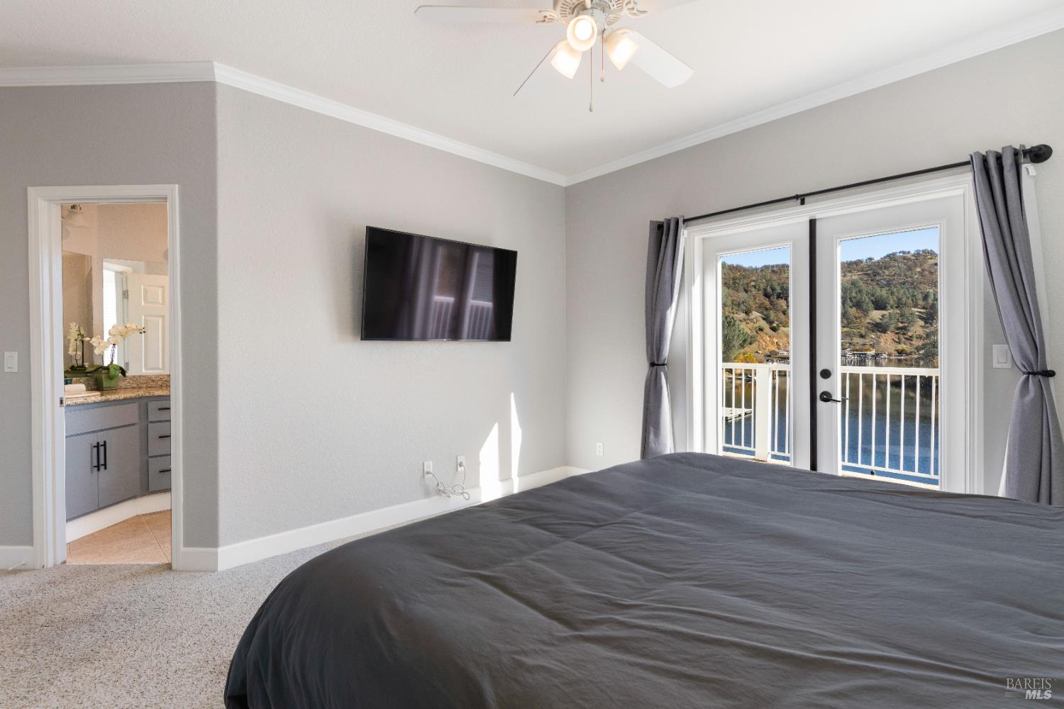 11115 Lakeshore Drive Clearlake, CA 95422 - Photo 35 of 69 a bedroom with a large bed and a flat tv screen