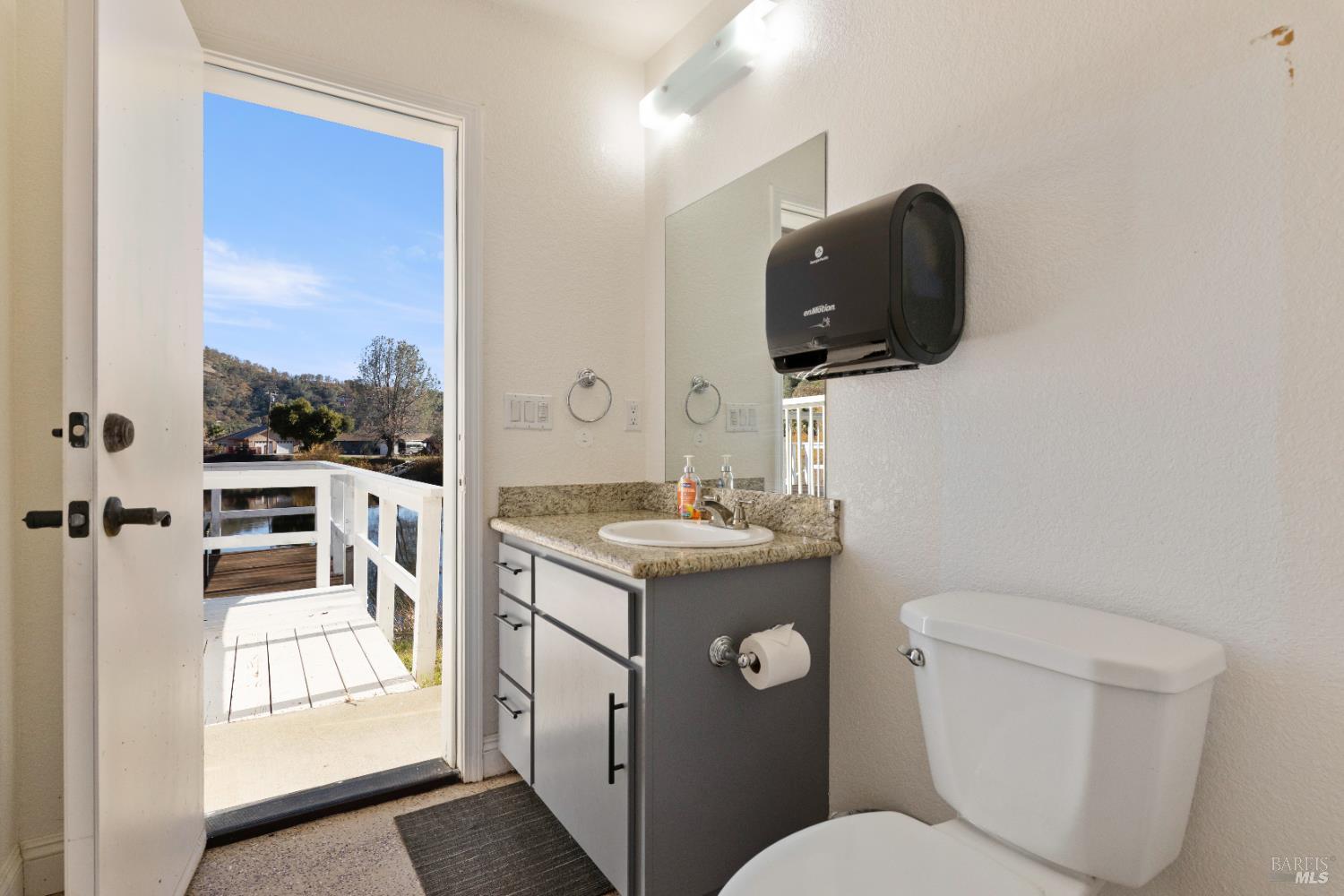 11115 Lakeshore Drive Clearlake, CA 95422 - Photo 61 of 69 a bathroom with a toilet sink and mirror