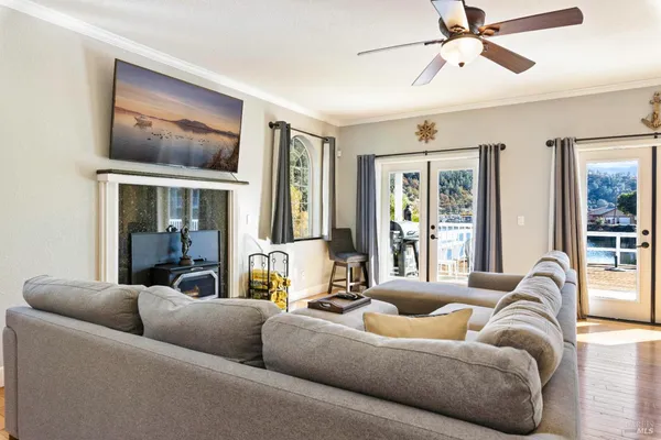 a living room with furniture a fireplace and a chandelier