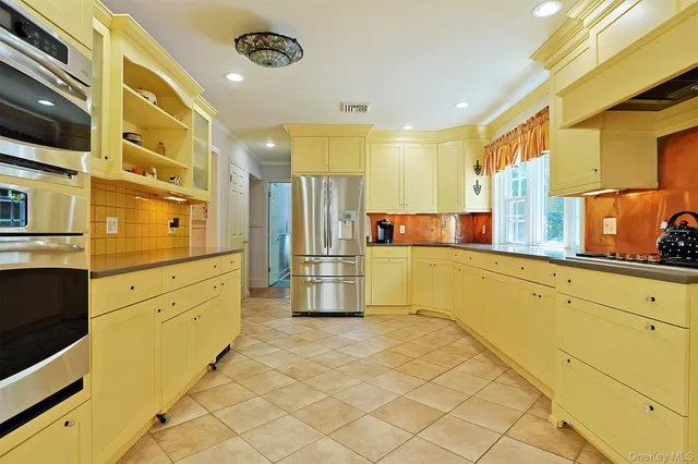a kitchen with stainless steel appliances granite countertop a refrigerator and a sink