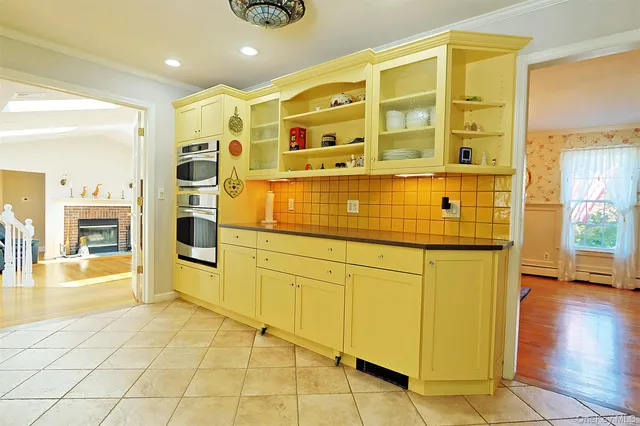 a spacious bathroom with a granite countertop sink and a mirror