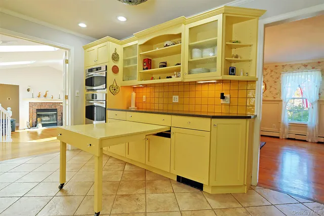 a kitchen with a sink a window and cabinets