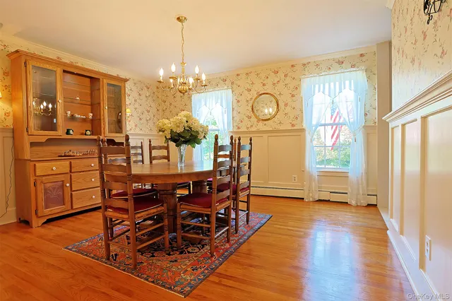 a view of entryway bedroom and hall with wooden floor