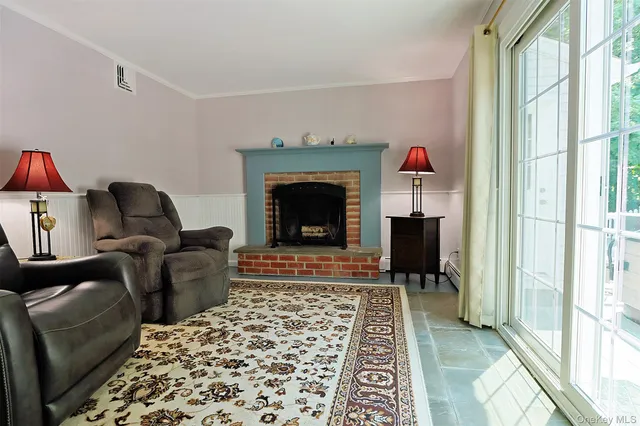 a living room with a black couch next to a large window