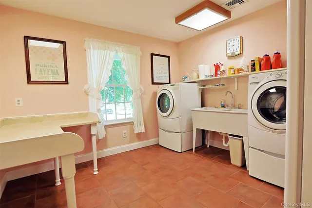 a bathroom with a sink a window and a shower