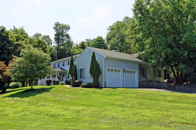 a front view of house with yard and green space