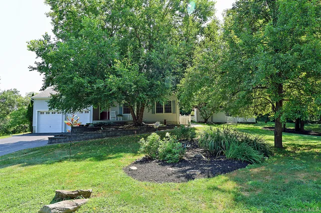 a view of a chair and table in backyard of the house