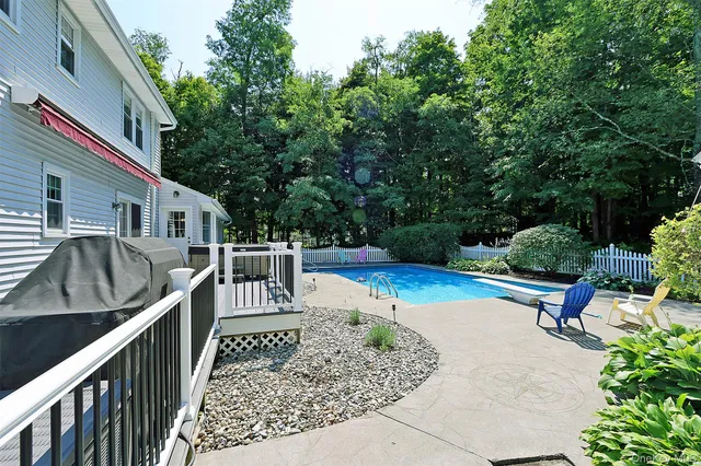 a view of a wooden deck and a backyard