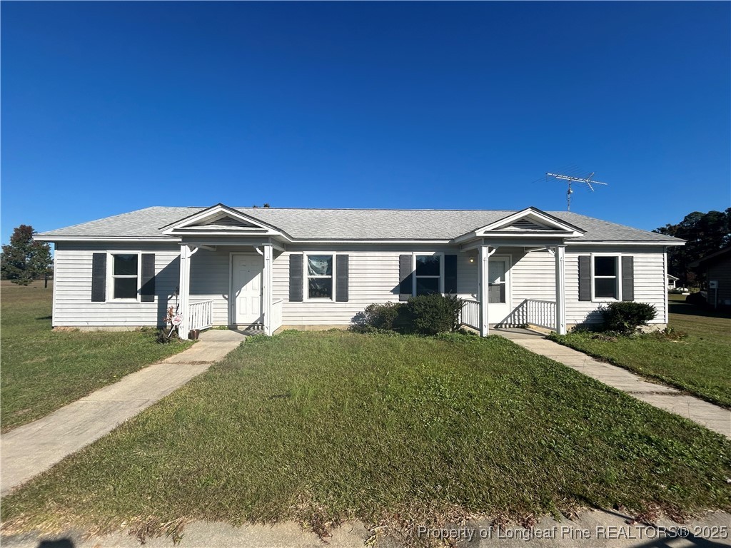 1378 Singletree Lane Raeford, NC 28376 - Photo 1 of 18 a front view of a house with a yard