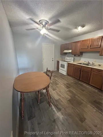 a kitchen with a refrigerator and a stove