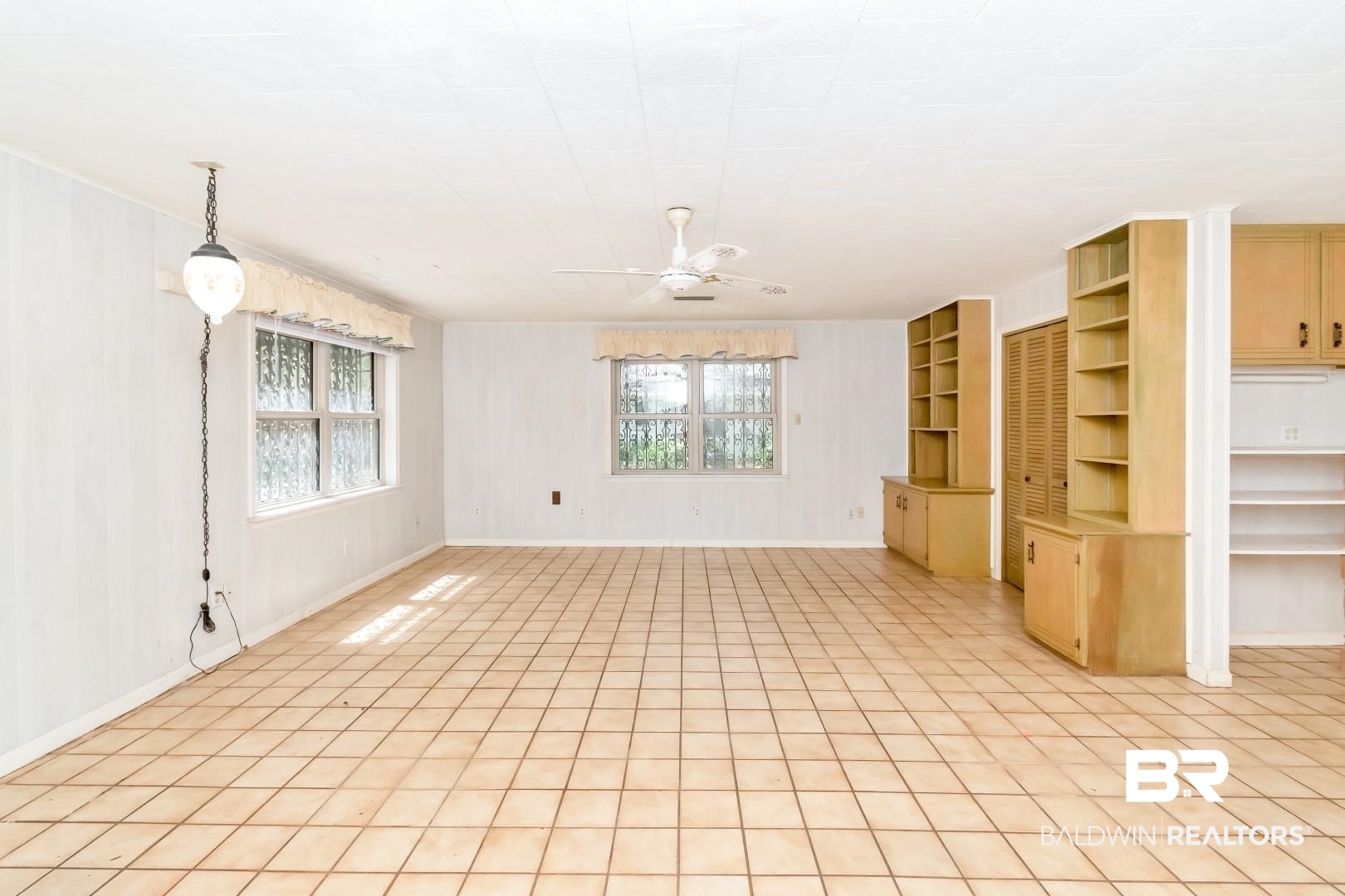 3715 South Conway Drive Mobile, AL 36608 - Photo 14 of 24 Unfurnished living room with plenty of natural light, baseboards, and ceiling fan